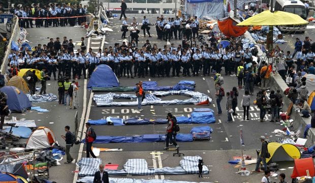 Hong Kong police haul protesters away as camp site is dismantled