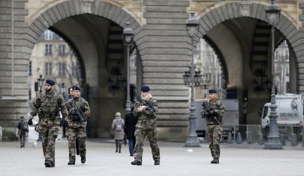 Hunt for two in French shooting that killed 12; one surrenders
