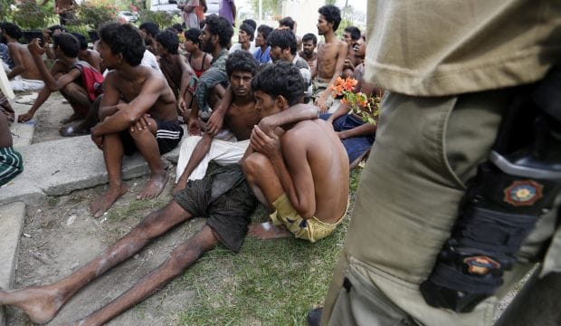 Malaysia intercepts migrants towed back to sea by Thais, thousands still adrift