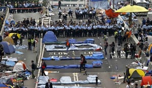 Hong Kong police haul protesters away as camp site is dismantled