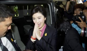 Thai court says ex-premier to stand trial over rice program