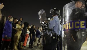 Two officers shot outside Ferguson police HQ after chief quits